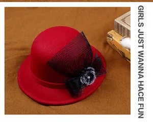 Detail of red wool felt cloche hat with black mesh bow, faux fur pom and pearl accent