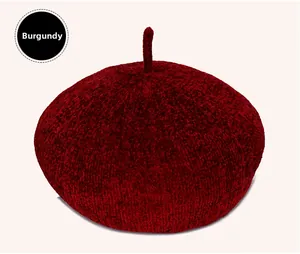 Detailed close-up of dark red knitted beret hat showing thick chenille fabric texture