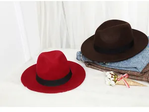 Detail of red and dark brown wool felt fedora hats with black ribbon bands for winter