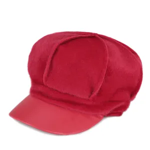 Red octagonal newsboy cap for women with faux fur texture and leather brim detail