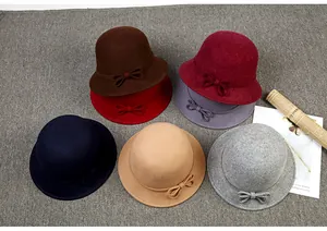 Flat lay of multiple Australian wool felt bucket hats with bow ribbons in various colors