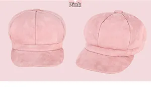 Detailed view of a pink suede newsboy cap with an octagonal crown and stiff brim