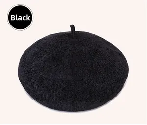 Detail showing the fine wool blend texture and classic top stem of a black beret hat