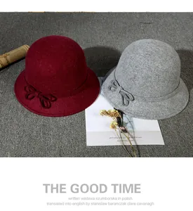 Close-up of wine red and dark grey wool cloche hats with elegant bow details