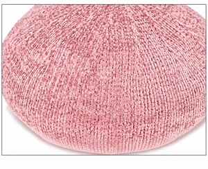 Close-up of pink knitted beret featuring soft wool texture and premium grainy fabric detail