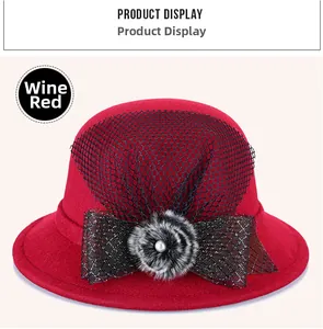 Detail view of burgundy wool felt hat with black mesh veil and pearl bow decoration