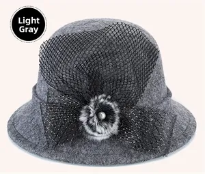 Detail of light grey wool felt hat with black mesh veil and pearl floral decoration