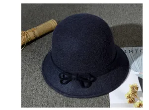 Detailed close-up of charcoal wool felt cloche hat featuring an elegant bow decoration