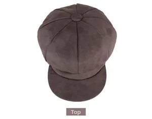Top view of dark brown newsboy cap showing eight-panel stitching and suede texture