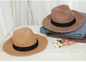 Close-up of wool fedora hats in camel and dark brown with elegant black ribbon bands