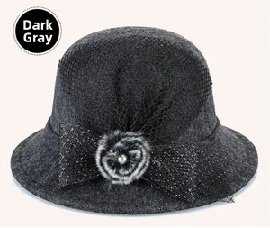 Detail of dark grey cloche hat with black mesh veil, bow and faux fur flower accent