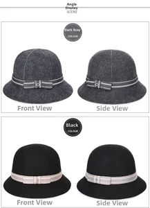 Dettaglio di cappelli cloche in lana grigio scuro e nero con fiocco a righe e fibbia in metallo