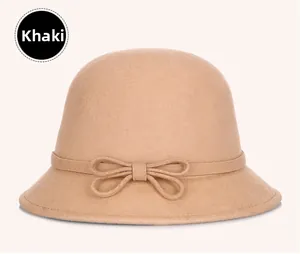 Detail shot of the khaki wool cloche hat featuring a minimalist elegant ribbon bow decoration