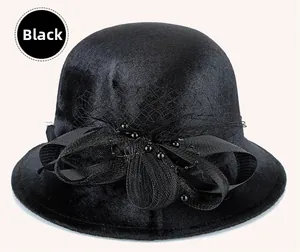 Detail of elegant black wool bucket hat featuring mesh veil and velvet flower bow
