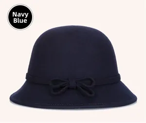 Detail shot of navy blue wool felt bucket hat featuring a delicate bow ribbon decoration