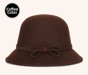 Detail of coffee brown wool felt hat with elegant bow and decorative ribbon trim