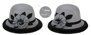 Detail of grey winter cloche hat with floral accent and soft faux fur trim decoration