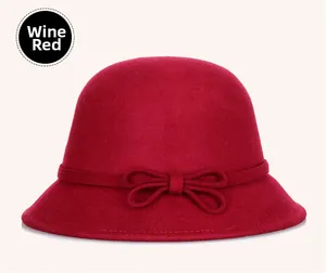 Close-up of wine red wool cloche hat showing premium felt texture and ribbon bow