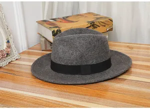 Close-up of wool fedora hat with wide black ribbon on a rustic wooden table top
