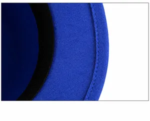 Macro view of blue wool fedora hat showing wide brim stitching and black inner sweatband
