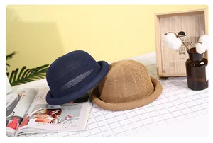 Close-up of elegant woven straw sun hats in navy and khaki with breathable mesh detail