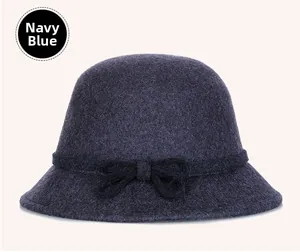 Detail of navy blue wool cloche hat featuring a decorative bow and textured felt finish