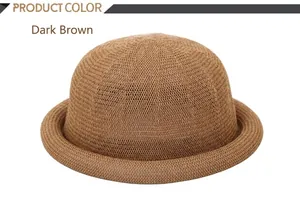 Detail of dark brown straw hat showing woven texture and elegant rolled brim design