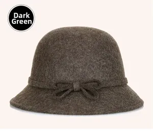 Detail of the dark green wool cloche hat with a matching bow tie decoration