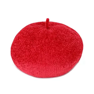 Vibrant red knit beret hat in retro style with textured chenille fabric on white background