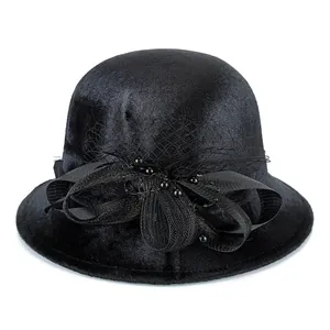Elegant black wool cloche hat for women featuring mesh veil and large velvet bow decoration