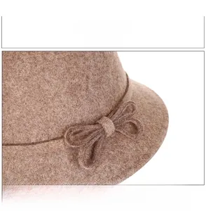 Detailed view of handmade bow decoration and fine Australian wool texture on brown felt hat