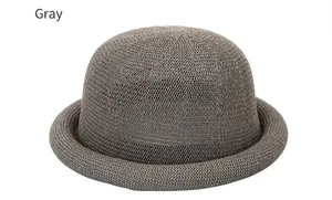 Detailed view of the wave-knit texture on a grey round-top summer straw hat for women