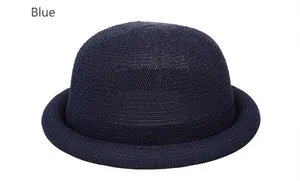 Detailed view of dark blue woven straw dome hat with elegant rolled brim texture