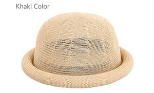 Detail view of khaki knitted straw dome hat featuring natural woven texture and rolled brim