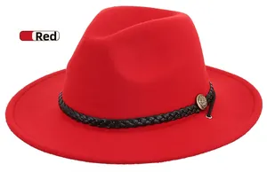 Detail of red wool felt fedora with black woven band and antique metal badge