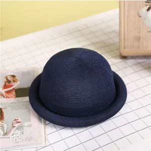 Elegant navy blue knitted bowler hat for women with a vintage round dome and rolled brim style