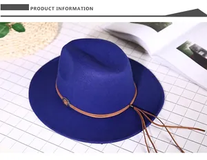 Detailed shot of royal blue fedora hat with brown leather rope and tassel ornament