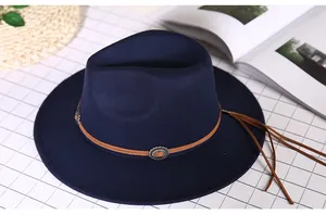 Close-up of navy blue wool fedora hat featuring a brown leather band and silver metal buckle