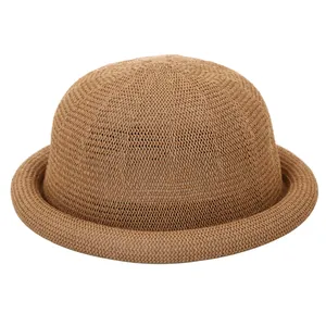 Elegant woven straw bowler hat for women with a curved brim in natural khaki color