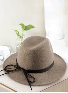 Detail shot of camel pure wool cowboy hat with leather band in cozy interior
