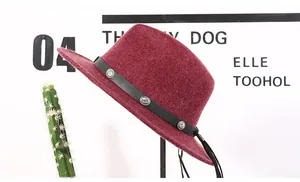Close-up of wine red wool fedora featuring black leather band with silver metal studs