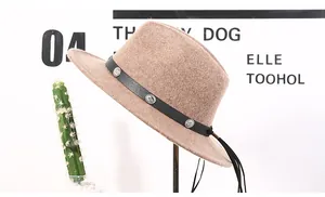 Detail of wool fedora with black leather band, silver conchos and long leather tassels