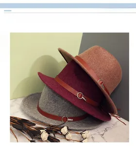 Three wool fedora hats in camel, wine red, and grey with brown leather bands and metal buckles