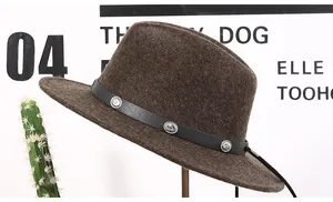 Close-up of dark brown wool felt fedora featuring black leather band and silver buckle