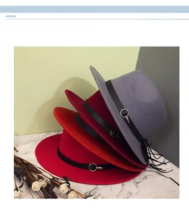 Close-up of wool fedora hats in grey and red with leather belts and metallic rings