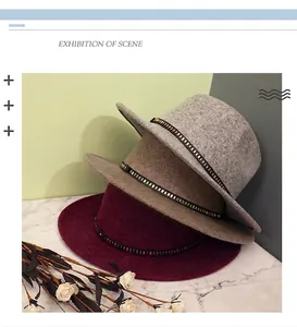 Close-up of wool fedora hats in grey, coffee and wine red with gold rivet metal bands