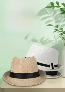 Detail of breathable knit jazz hats with black ribbons in beige and white