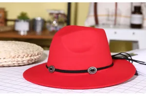 Detail of red wool fedora with black decorative band and silver embossed metal buckles