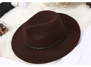 Detailed macro view of dark brown felt fedora hat with studded leather band and rivets