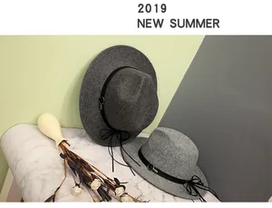 Detailed close-up of wool fedora hats with stylish black leather bands and metal ring accents